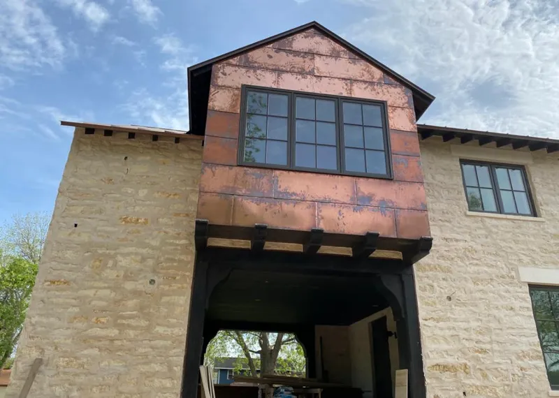 Copper metal panel facade on a stone building for Metal Roof Coating in Arlington